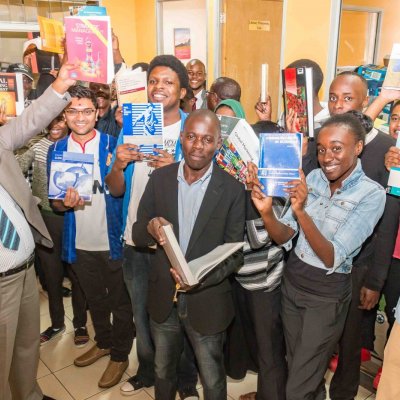 Riara University staff and students receiving the textbooks. 